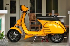 a yellow scooter parked in front of a house