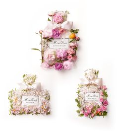 three small boxes with flowers and ribbons on them