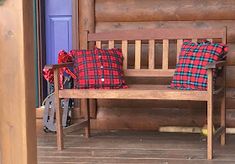 a wooden bench with two pillows on it