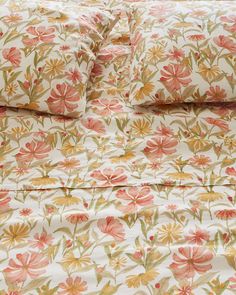 an image of a bed with floral sheets and pillowcases on top of it