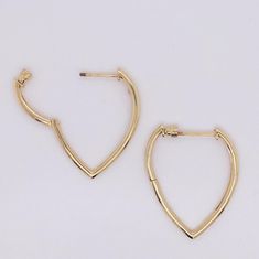 Show your stylish flair with this contemporary twist on classic hoop earrings! Vibrant contrast shines in the rounded hoop top that flares out then slims down into a rounded point to form an inverted droplet or pear shape. The cleanly bright solid 14 karat yellow gold look can be casual to elegant depending on how you want to dress! The "screwback" threaded posts and backs on these hoops are a fabulous secure upgrade to the standard post options for hoops. Just like the security some people love Modern Small Hoop Teardrop Earrings For Pierced Ears, Teardrop Hoop Earrings With Polished Finish For Formal Occasions, Teardrop Hoop Earrings With Polished Finish For Formal Events, Modern Teardrop Huggie Earrings With Polished Finish, Formal Teardrop Huggie Earrings With Polished Finish, Elegant Polished Teardrop Huggie Earrings, Modern Teardrop Single Huggie Earring, Elegant Teardrop Huggie Earrings With Polished Finish, Modern Drop Hoop Earrings