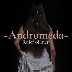 the back of a woman's head with her hands on her hips, in front of an ad for andromeda