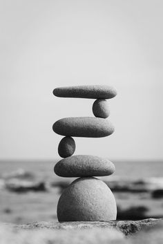 rocks stacked on top of each other in front of the ocean