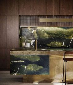 a modern kitchen with marble counter tops and wooden cabinets, along with two bar stools