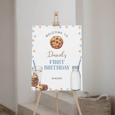 a welcome sign for a baby's first birthday with cookies and milk on it