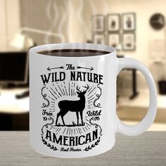 a white coffee mug with the words wild nature and an image of a deer on it