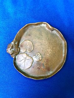 a metal tray with flowers and leaves on it