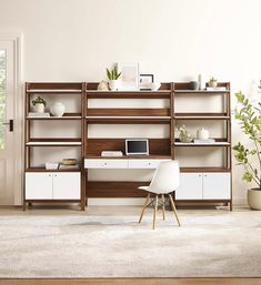 a white chair sitting in front of a computer desk on top of a wooden shelf