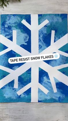 a paper snowflake with the words tape resist snow flakes