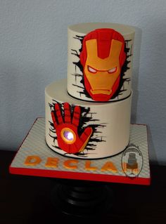 two tiered cake decorated with iron man faces