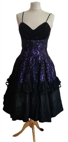 A fabulous party dress by Caroline Walker of London Dance the night away in this stunning gown   This fit and flare dress is black velvet lace & satin, The bodice is boned with a sweetheart neckline.  Fitted  waist and the most wonderfully full skirt with layers and layers of purple tulle, the colour purple looks absolutely stunning underneath the Lace  This is a truly Elegant beautiful dress Excellent condition Gothic Prom Dress With Boned Bodice, Halloween Velvet Party Dress, Gothic Victorian Dress With Fitted Bodice For Party, Fitted Velvet Ball Gown, Velvet Evening Dress For Halloween, Halloween Evening Dress With Boned Bodice, Formal Lace Overbust Dress, Vintage Halloween Party Dress, Vintage Ball Gown For Costume Party