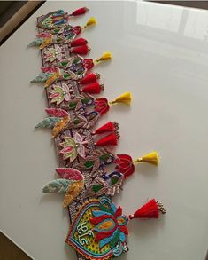 an elaborately decorated table runner with tassels