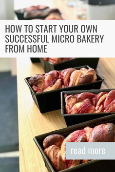 four trays filled with pastries sitting on top of a wooden table next to each other