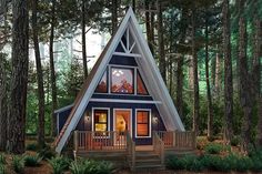 a - frame cabin in the woods with stairs leading up to it