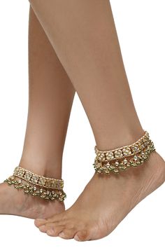 22k gold plated pair of anklets with embellished pearls, floral motifs and encrusted jadtar stones.
Type: Jadtar stone, Pearl, Bead
Composition: Silver and Copper Mix
Color: Gold
Floral motifs
Cluster beads
Closure: Hook - Aza Fashions Gold Kundan Necklace With Zari Work For Designer Wear, Gold Kundan Necklace For Designer Festivals Wear, Gold Kundan Necklace For Designer Wear, Elegant Stone Work Anklets For Wedding, Festive Kundan Anklets With Stone Work, Kundan Anklets For Wedding And Diwali, Elegant Stone Work Anklets For Festive Occasions, Festive Stone Work Anklets, Festive Meenakari Anklets For Wedding