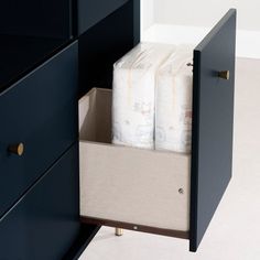 a drawer with two rolls of toilet paper in it and another roll of tissue on the bottom