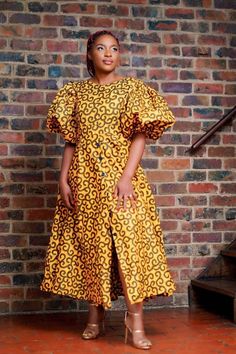 Long African print dress. Puff sleeves. Zipper closure. Ankara Puff Sleeve Dress, Flare Dresses Ankara, Modern African Print Dresses, Bubu Gowns, African Print Kimono, Puffy Sleeve Dress, Long Dress Patterns, Modern Dresses, Ankara Short Gown Styles