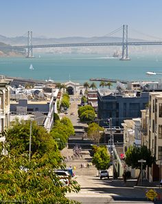 a view of the bay bridge in san francisco, california with lots of buildings on both sides