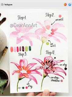 a person holding up a card with watercolor flowers on it and instructions for how to paint them