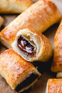 several pastries with chocolate filling on top