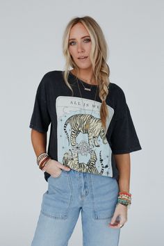 You're going to bring all the good boho vibes wherever you go with this beautiful graphic design, the All Is Well Tiger Graphic Tee is a stand - out and cool! You'll love wearing it because it features: Comfortable mineral - washed Cotton tee shirt fabric Loose and oversized tee shirt silhouette Classic crew neckline and dropped shoulders with loose short sleeves So cute "All Is Well" tiger graphic along the front Pair with: Floral Textured Padded Bralette, The Signature Flare, and Carson Charme Trendy Acid Wash Tops For Festivals, Soft-washed Relaxed Fit Tops For Festival, Festival Graphic Tee With Vintage Wash, Trendy Acid Wash Tops With Front Print, Trendy Acid Wash Top With Front Print, Festival Acid Wash Tops With Screen Print, Acid Wash Screen Print Tops For Festival, Relaxed Fit Washed Top For Festivals, Acid Wash Soft-washed Tops For Festival