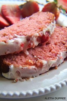 two pieces of cake on a plate with strawberries