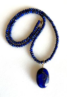 Lapis lazuli beaded gemstone necklace with large two sided gold edged lapis lazuli pendant wire wrapped in gold fill.  AAA natural micro faceted 4mm blue lapis rondelles beaded with 24 x 18 x 8mm gold edged lapis gemstone on gold vermeil twisted ring as focal. Natural lapis lazuli from Afghanistan is not treated in any way.    Stunning pendant necklace is made to order with 14k gold fill clasp.  Pairs beautifully with gold vermeil lapis  choker sold separately in shop. Please see last photo abov Lapis Lazuli Gemstone Beads Pendant Jewelry, Elegant Lapis Lazuli Natural Stone Necklace, Gold Lapis Lazuli Gemstone Necklace, Lapis Lazuli Pendant In Yellow Gold, Luxury Gold Lapis Lazuli Beaded Necklace, Jewelry Chest, Lapis Lazuli Pendant, Lapis Lazuli Beads, Twist Ring