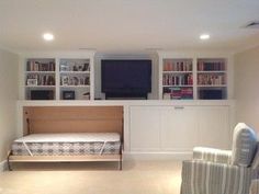 a living room filled with furniture and a flat screen tv mounted to the side of a wall