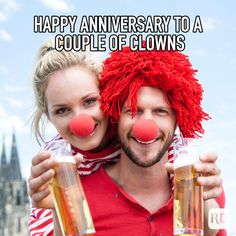 a man and woman with clown noses holding beer mugs