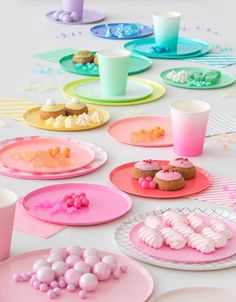 a table topped with plates and cups filled with desserts