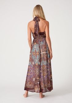 A stunning chiffon halter maxi dress in a purple paisley and floral print. FINAL SALE Paisley and floral print Chiffon Relaxed fit Sleeveless Maxi length Halter tie neckline Front keyhole detail Half-smocked elastic bodice at the back Ruched top detail Lined Bohemian spring maxi dress Introducing our stunning chiffon halter maxi dress, featuring a bold paisley and floral print. The half-smocked elastic bodice at the back creates a flattering fit, while the halter tie neckline adds an elegant tou Chic Flowy Paisley Print Maxi Dress, Chic Flowy Maxi Dress With Paisley Print, Bohemian Chiffon Halter Neck Dress, Purple Chiffon Maxi Dress For Beach, Elegant Paisley Print Maxi Dress For Vacation, Flowy Paisley Print Maxi Dress, Sleeveless Paisley Print Maxi Dress For Vacation, Flowy Maxi Dress With Paisley Print, Chic Sleeveless Paisley Print Maxi Dress