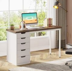 an office desk with drawers and a computer monitor on it in front of a window