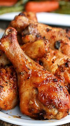 chicken wings on a plate with carrots in the background