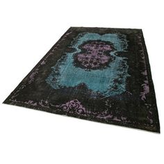 a black and blue rug with an ornate design on the bottom, in front of a white background