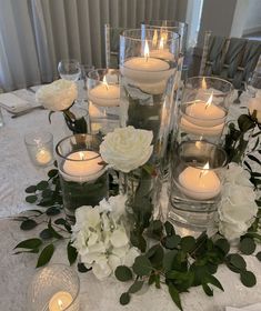 a table topped with lots of candles and flowers