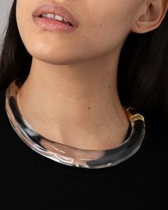 Sculpted crystal clear Lucite collar, modern in form. Capped with 14k gold plated hinged end cap. 14k gold plated brass, Lucite Lucite is hand-carved and hand-polished in Brooklyn, NY Modern Formal Hinged Jewelry, Modern Round Lucite Jewelry, Elegant Lucite Jewelry For Formal Occasions, Formal Gold Lucite Jewelry, Clear Luxury Jewelry For Formal Occasions, Luxury Clear Jewelry For Formal Occasions, Formal Clear Jewelry With Polished Finish, Formal Clear Lucite Jewelry, Lucite Jewelry