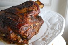 a piece of meat sitting on top of a white plate