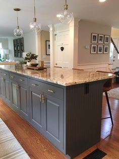 a large kitchen island with marble counter tops