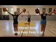 two girls in black shirts and cheerleaders holding pom poms