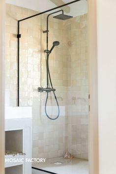 Transform your bathroom with timeless beige Zelliges tiles that span from floor to ceiling, paired with sleek black faucets for a striking contrast. SYJ. La Maisom is a complete renovation of a 166m² holiday home in Camargue that blends classic charm with modern elegance designed by Design by Chloé from (IG)gigi.by.c____studio. Save this pin for more renovation inspiration! Photography by (IG)mylene.cmt.