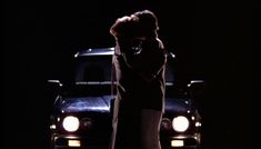 a man standing in front of a truck at night