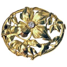 Art Nouveau 18K Diamond Brooch, C.1900. The brooch of oval pierced foliate design, the main floral petal set in the centre with a small old cut diamond. Trombone clasp to reverse. Measures: 3.00 x 2.00 cm. Item Weight: 4.30 grams. Acid tested 18K. Georgian Jewelry, Edwardian Jewelry, Art Nouveau Jewelry, Diamond Brooch, Antique Buttons, Trombone, Classic Art, Antique Jewelry, Fashion Art