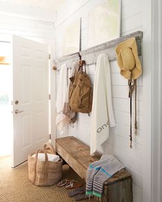 a wooden bench sitting in front of a white door next to a pair of shoes