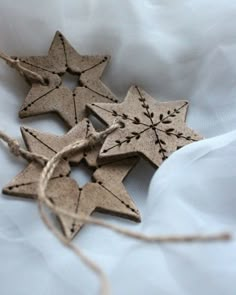 three wooden stars are tied together with twine