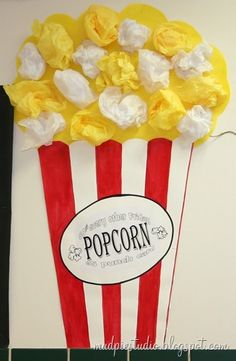 a popcorn bag with flowers in it and the word popcorn written on it is attached to a wall