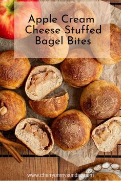 apple cream cheese stuffed bagel bites on a wooden table with apples and cinnamon sticks