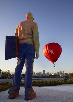 a man standing next to a hot air balloon