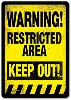 a yellow and black warning sign with the words'warning restricted area keep out '