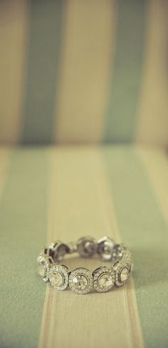 a diamond ring sitting on top of a table