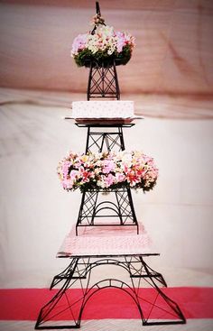 the eiffel tower is decorated with pink and white flowers on it's sides